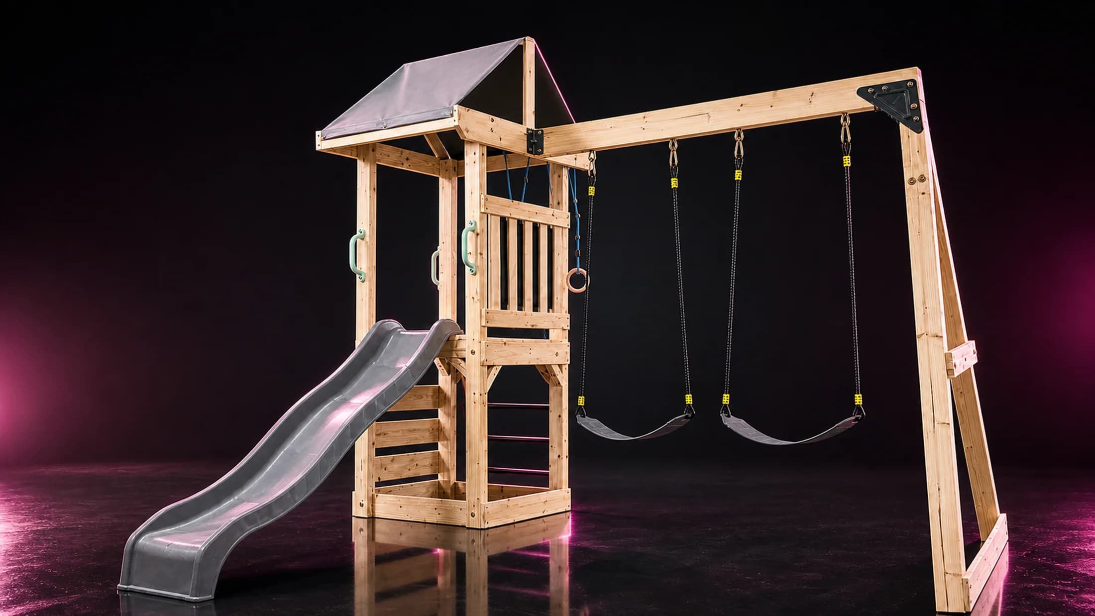 Spotlight AAW0034 shown on a dark play-loop stage with slide, swings, tower, climbing wall, and ladder visible.